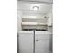 A conveniently located laundry room with washer, dryer, and shelving at 3020 Heathstead Pl # A, Charlotte, NC 28210