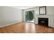 Inviting living room with hardwood floors, a fireplace, and sliding glass doors to a patio at 3020 Heathstead Pl # A, Charlotte, NC 28210