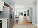 Open concept living area connecting kitchen, dining, and living spaces with hardwood floors at 3020 Heathstead Pl # A, Charlotte, NC 28210