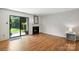 Bright living room with a fireplace, sliding glass doors and hardwood floors at 3020 Heathstead Pl # A, Charlotte, NC 28210