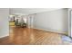 Open living space with hardwood floors seamlessly connecting the living room to the kitchen at 3020 Heathstead Pl # A, Charlotte, NC 28210