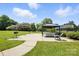 Outdoor space with a gazebo, picnic tables, grill, and lounge chairs in a grassy area at 3020 Heathstead Pl # A, Charlotte, NC 28210