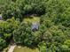 Aerial view of a secluded house surrounded by dense trees and a well-maintained lawn at 3020 Waxhaw Crossing Dr, Waxhaw, NC 28173