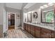 Bathroom with a dual sink granite vanity, an arched window, and a walk in closet at 3020 Waxhaw Crossing Dr, Waxhaw, NC 28173