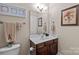 This stylish half bathroom features attractive vanity, framed mirror, and monogrammed towel set at 3020 Waxhaw Crossing Dr, Waxhaw, NC 28173