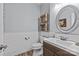 Stylish half bath with shiplap walls, wood-look tile flooring, modern fixtures, and decorative shelves at 3020 Waxhaw Crossing Dr, Waxhaw, NC 28173