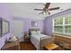 Bedroom featuring lavender walls, wicker furniture, hardwood floors, and natural light at 3020 Waxhaw Crossing Dr, Waxhaw, NC 28173
