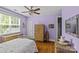 A beautifully decorated bedroom with hardwood floors, woven furniture, and a ceiling fan at 3020 Waxhaw Crossing Dr, Waxhaw, NC 28173