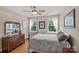 Inviting bedroom with a wooden bed frame, hardwood floors, and natural light streaming through the windows at 3020 Waxhaw Crossing Dr, Waxhaw, NC 28173