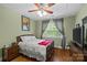 Bright bedroom offering hardwood floors, neutral paint, window view, and fan at 3020 Waxhaw Crossing Dr, Waxhaw, NC 28173