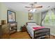 Bedroom with hardwood floors, fan, a vintage display cabinet and natural light at 3020 Waxhaw Crossing Dr, Waxhaw, NC 28173