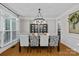 Formal dining room with modern chandelier, large window, and seating for six at 3020 Waxhaw Crossing Dr, Waxhaw, NC 28173