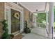 Inviting front porch with brick accents, decorative wreath, and elegant landscaping at 3020 Waxhaw Crossing Dr, Waxhaw, NC 28173