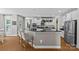 Open kitchen design features an island with breakfast bar, white cabinets, and stainless appliances at 3020 Waxhaw Crossing Dr, Waxhaw, NC 28173