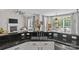 Modern kitchen features granite countertops and a double sink, with view to a fireplace at 3020 Waxhaw Crossing Dr, Waxhaw, NC 28173