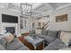 Cozy living room features a fireplace, built-in shelving, hardwood floors and coffered ceilings at 3020 Waxhaw Crossing Dr, Waxhaw, NC 28173