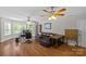 Spacious living room with hardwood floors, a leather sofa, and a dedicated workspace at 3020 Waxhaw Crossing Dr, Waxhaw, NC 28173