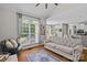 Open floor plan with a neutral living room featuring a large window, hardwood floors, and access to a dining area at 3020 Waxhaw Crossing Dr, Waxhaw, NC 28173