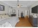 Large main bedroom with hardwood floors, ceiling fan, an ensuite bathroom, and ample storage space at 3020 Waxhaw Crossing Dr, Waxhaw, NC 28173
