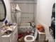 Bathroom with tiled shower and toilet and personal items scattered about the room at 32891 Nc 49 Hwy, New London, NC 28127
