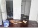 Bedroom with peeling floors, an open door and personal items scattered on the floor at 32891 Nc 49 Hwy, New London, NC 28127