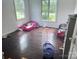 Bedroom with peeling floors, two windows and two beds at 32891 Nc 49 Hwy, New London, NC 28127