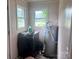 Functional laundry area with black washer and water heater; features two bright windows offering natural light at 32891 Nc 49 Hwy, New London, NC 28127