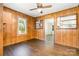 Living room with wood paneling, hardwood floors, and two windows at 3425 Long Ferry Rd, Salisbury, NC 28146