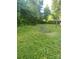 A spacious, grassy backyard presents a wonderful canvas for landscaping or recreational enjoyment at 3774 Seaman Dr, Charlotte, NC 28217
