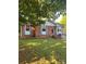 A lovely brick home with a well-kept lawn, complemented by stylish blue shutters and a welcoming entrance at 3774 Seaman Dr, Charlotte, NC 28217