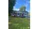 Charming brick home with blue shutters and a well-manicured lawn, perfect for outdoor activities at 3774 Seaman Dr, Charlotte, NC 28217