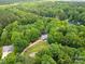 Expansive aerial view of a wooded property, featuring the house and surrounding greenery at 402 Wildlife Rd, Troutman, NC 28166