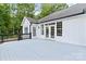 Spacious back deck with light-colored painted wood, railing, and access to the home's interior at 402 Wildlife Rd, Troutman, NC 28166