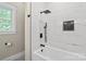 Modern bathroom with a soaking tub, white marble, black fixtures and window, offering a relaxing space at 402 Wildlife Rd, Troutman, NC 28166