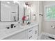 Stylish bathroom featuring double sinks, modern fixtures, and a large window for natural light at 402 Wildlife Rd, Troutman, NC 28166