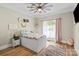 Cozy bedroom with a white bed, hardwood floors, and a window providing natural light at 402 Wildlife Rd, Troutman, NC 28166
