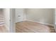 This bedroom offers ample space with light-colored vinyl flooring and a closet near the staircase at 402 Wildlife Rd, Troutman, NC 28166