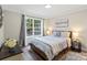 Comfortable bedroom featuring a large window, decorative crown molding, and stylish furnishings at 402 Wildlife Rd, Troutman, NC 28166