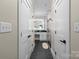 Hallway with access to modern bathroom featuring a double sink vanity and marble-tiled shower at 402 Wildlife Rd, Troutman, NC 28166
