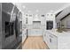 Modern kitchen with stainless steel appliances, white cabinets and a stone island at 402 Wildlife Rd, Troutman, NC 28166