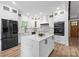 Modern kitchen with white cabinets, a marble island, and stainless steel appliances at 402 Wildlife Rd, Troutman, NC 28166