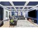 Finished basement living room with custom ceiling, black leather seating, a large tv, and access to the back yard at 402 Wildlife Rd, Troutman, NC 28166