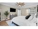 Spacious main bedroom with natural light, wood floors, decorative ceiling fan, and modern furnishings at 402 Wildlife Rd, Troutman, NC 28166