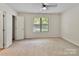 Neutral bedroom with a large window, ceiling fan, and closet at 407 Sweetgum Dr # B, Fort Mill, SC 29715