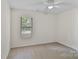 Clean bedroom featuring a window, ceiling fan, and neutral carpet at 407 Sweetgum Dr # B, Fort Mill, SC 29715