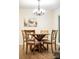 Bright dining room with wooden table, seating for four, and elegant chandelier at 407 Sweetgum Dr # B, Fort Mill, SC 29715