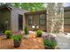 Charming home exterior with a stone chimney, wooden paneling, and manicured landscaping at 407 Sweetgum Dr # B, Fort Mill, SC 29715