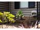 Close-up of a cozy seating area on the front porch, accented with flowers and greenery at 407 Sweetgum Dr # B, Fort Mill, SC 29715