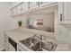Kitchen sink view to adjacent living room with white countertops and cabinetry at 407 Sweetgum Dr # B, Fort Mill, SC 29715