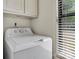 Bright laundry room features a white washer and built in storage cabinets with outdoor views at 407 Sweetgum Dr # B, Fort Mill, SC 29715